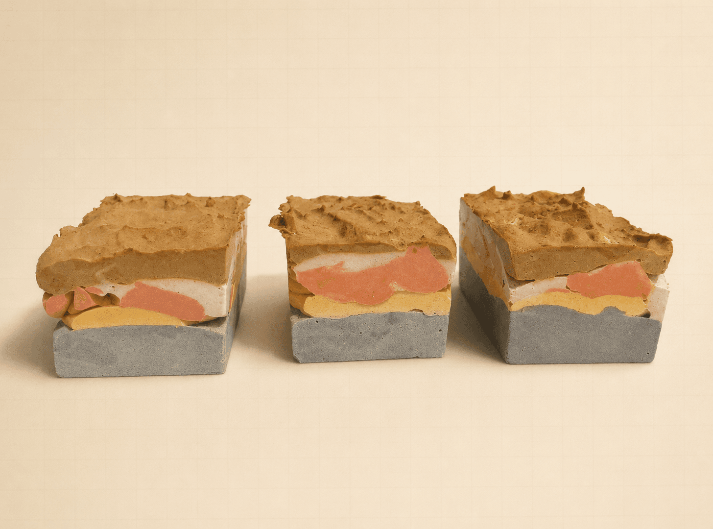 Three layered DigQuest excavation blocks showing visible colored strata.